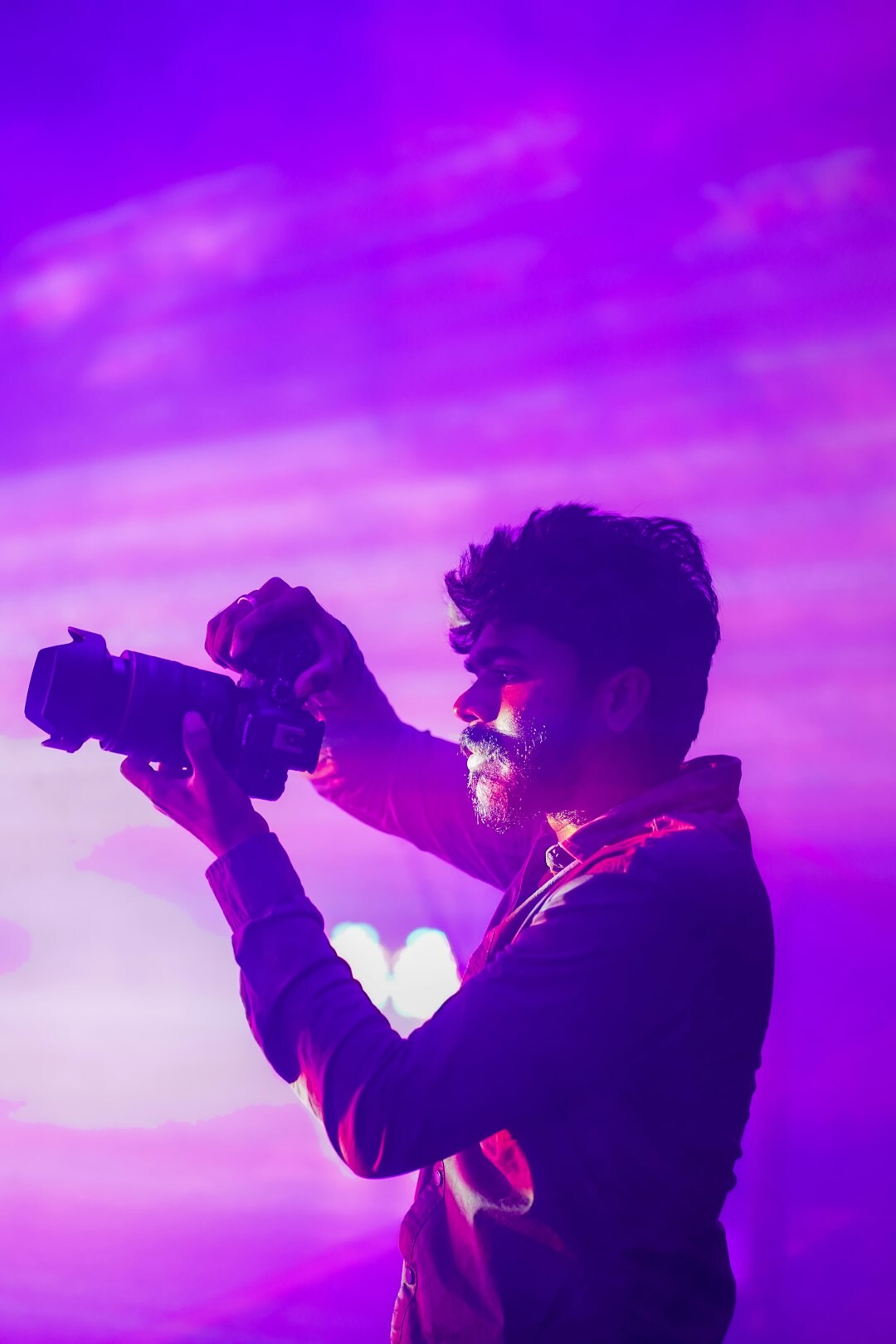 Portrait of a Danish documentary photographer holding a camera
